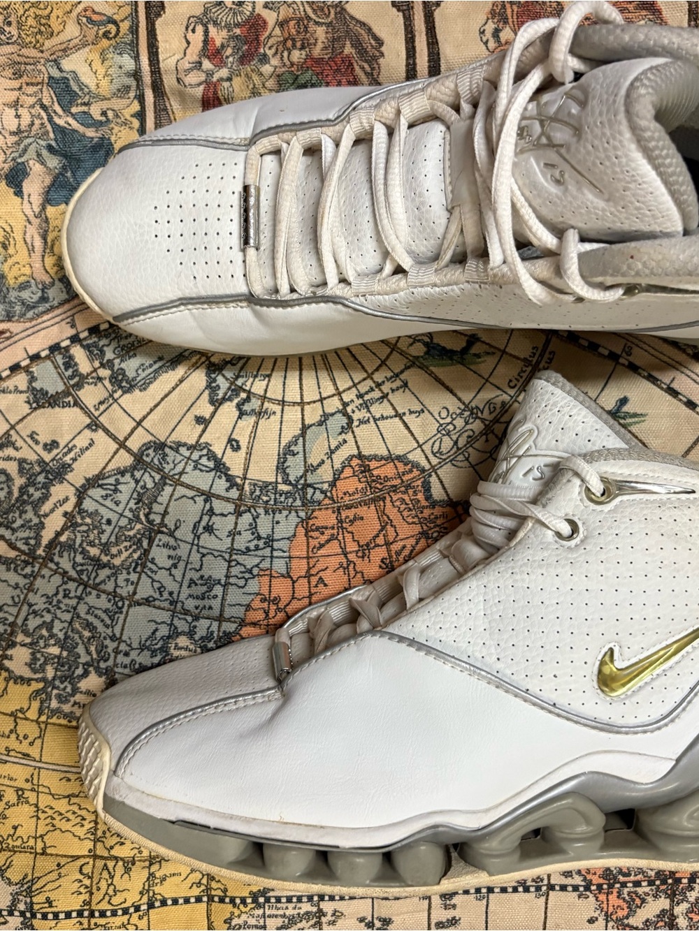 Nike White High-Top Sneakers with Gold Swoosh